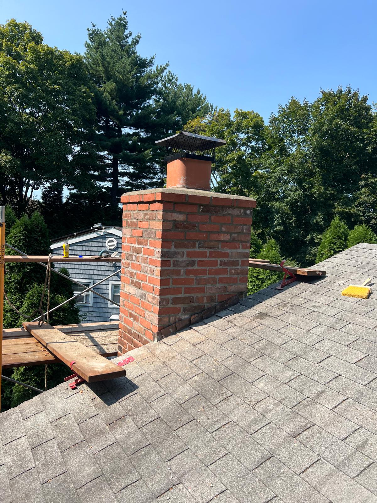 Finished brick chimney with a masonry cap
